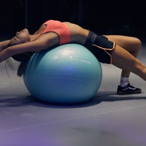 woman doing yoga on stability ball